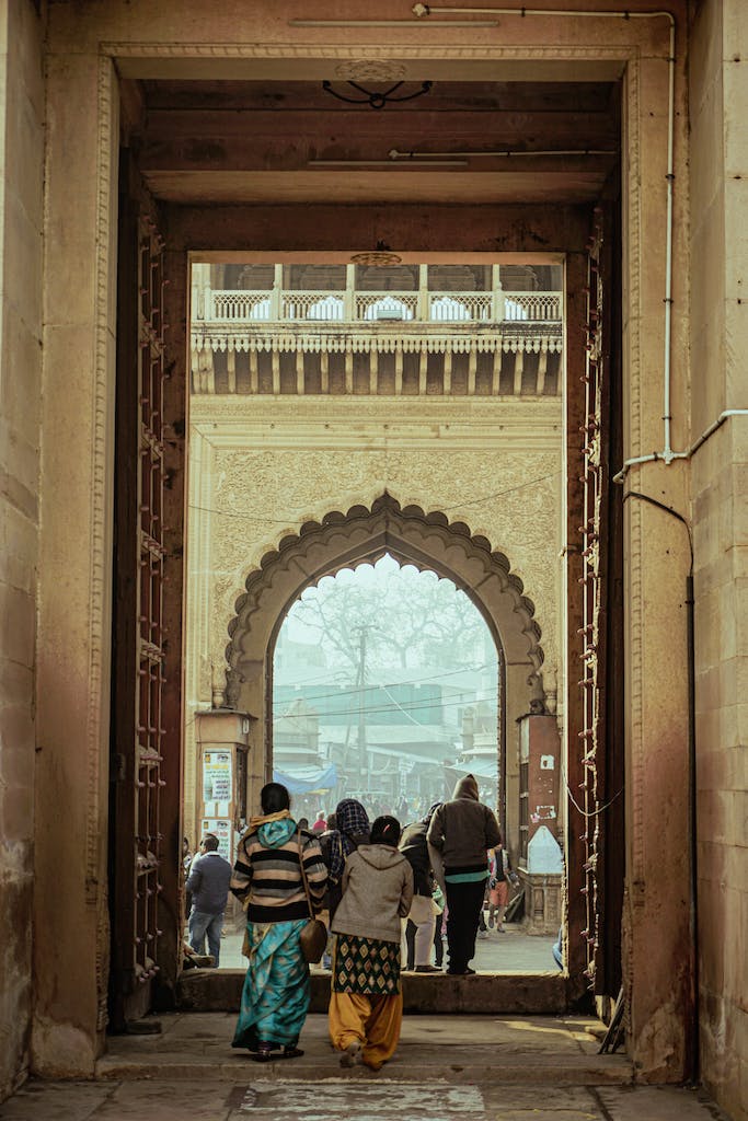 People walking through an archway in a city